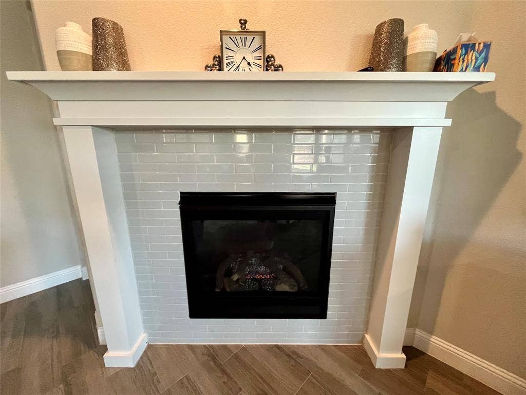 3636 Wintergreen Street, Grand Prairie, TX 76065 Fireplace with a white mantel, gloss subway tile surround, and black firebox