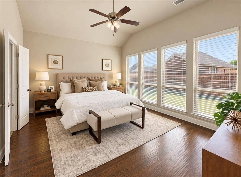 16116 Plum Court, Prosper, TX 75078 Vaulted ceiling with a ceiling fan, wood-finish flooring, four expansive windows, light-toned walls, and white trim