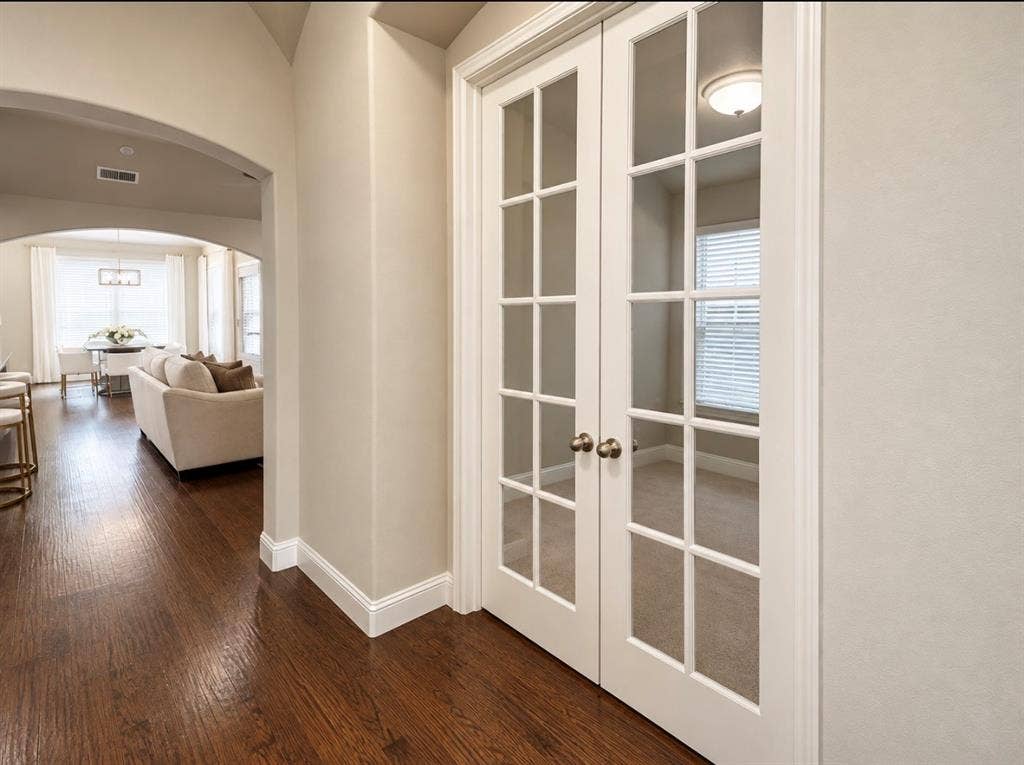 16116 Plum Court, Prosper, TX 75078 Rich wood-finish flooring, arched doorway, white trim, and French doors