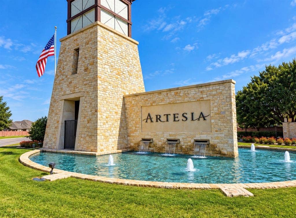16116 Plum Court, Prosper, TX 75078 Stone entry monument with a prominent tower, integrated water features, and a clear community sign