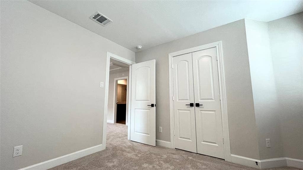 1101 Princeton Heights, Princeton, TX 75407 Carpeted flooring with light-toned walls, white trim, and a white interior door with black hardware