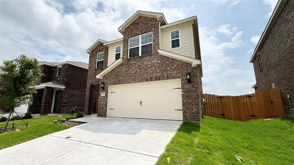 1101 Princeton Heights, Princeton, TX 75407 Two-story residence featuring a brick and siding exterior, an attached two-car garage, and a concrete driveway