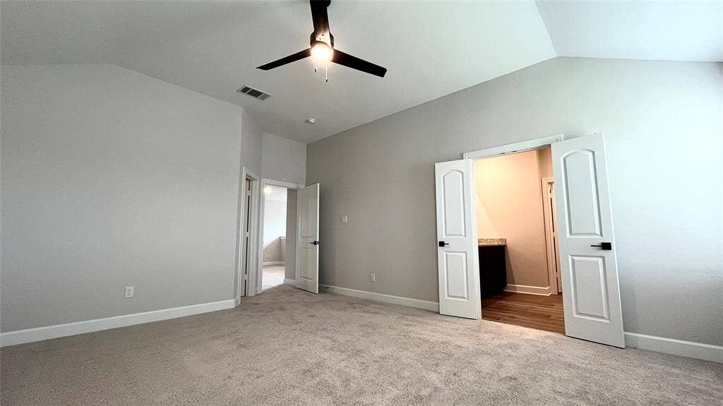 1101 Princeton Heights, Princeton, TX 75407 Carpeted flooring, vaulted ceiling with a ceiling fan, light-colored walls, and white interior doors with black hardware
