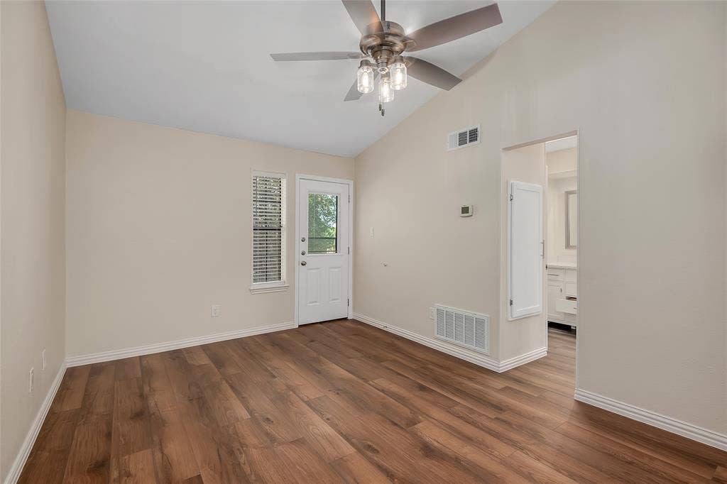 3635 Garden Brook Drive, #20200L, Farmers Branch, TX 75234 Vaulted ceiling with a ceiling fan, wood-finish flooring, and a white door with integrated blinds