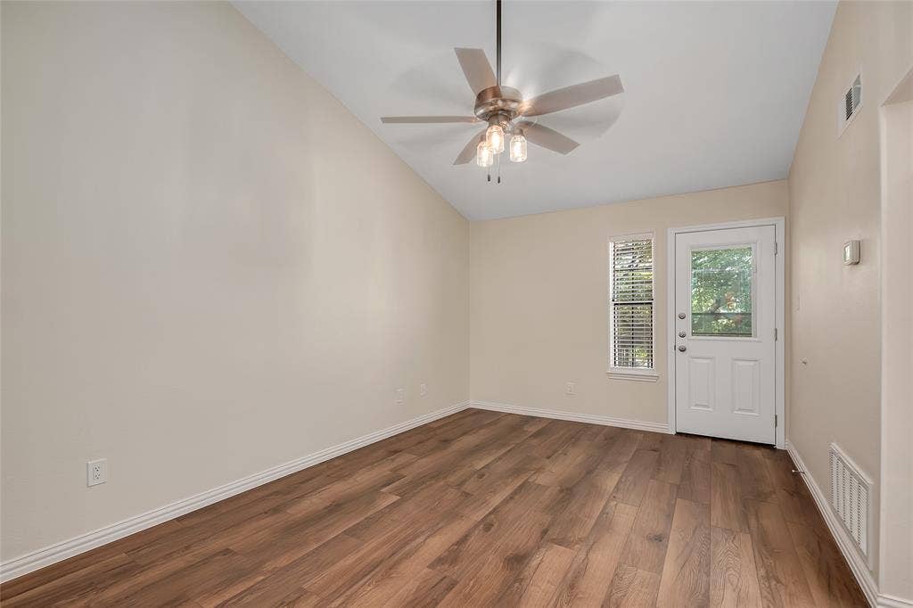 3635 Garden Brook Drive, #20200L, Farmers Branch, TX 75234 Vaulted ceiling with a ceiling fan, wood-finish flooring, white paneled door with glass insert, and a window with blinds