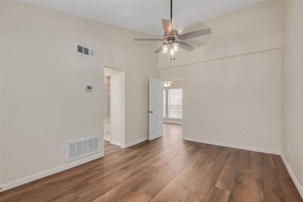 3635 Garden Brook Drive, #20200L, Farmers Branch, TX 75234 Vaulted ceiling with a ceiling fan, wood-finish flooring, and white trim