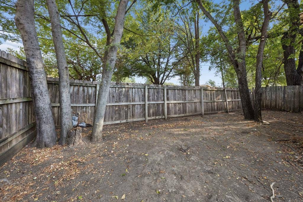 1613 19th Street, Plano, TX 75074 Private backyard space with wood fencing and mature trees