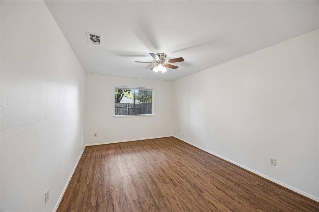 1613 19th Street, Plano, TX 75074 Wood-finish flooring, ceiling fan with integrated lighting, and a window with exterior views