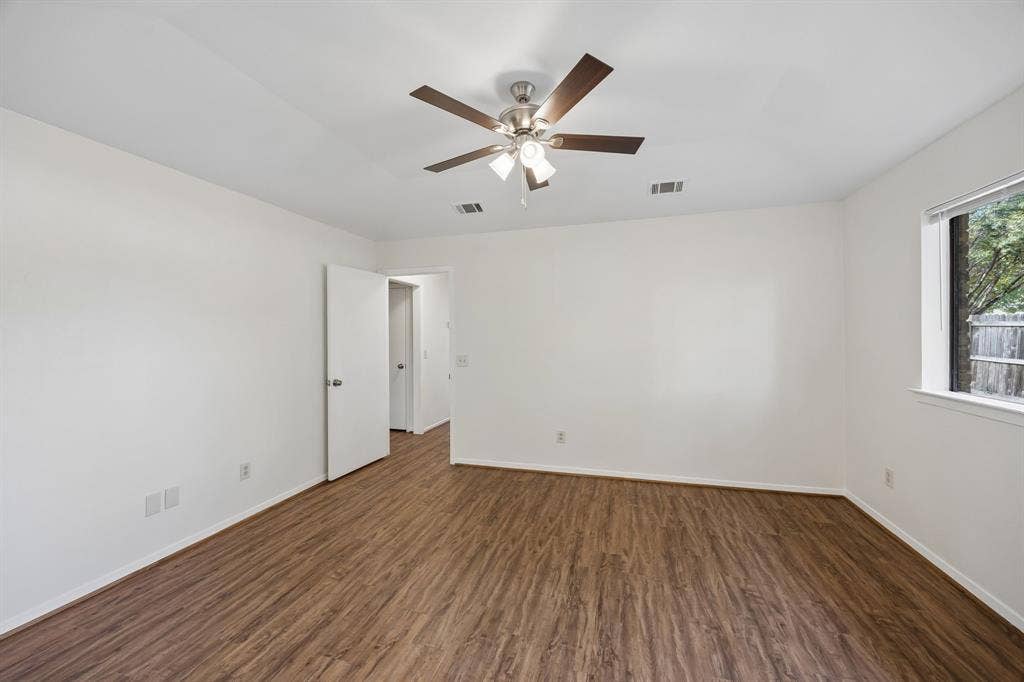 1613 19th Street, Plano, TX 75074 Wood-finish flooring with white walls and trim