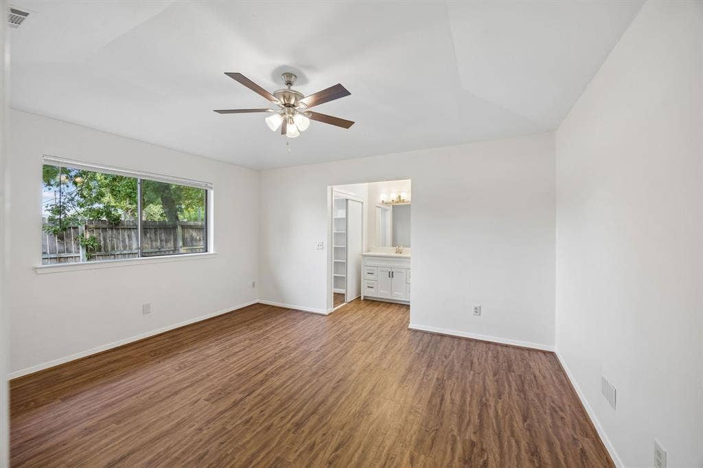 1613 19th Street, Plano, TX 75074 Wood-finish flooring, white walls, and a ceiling fan with integrated lighting