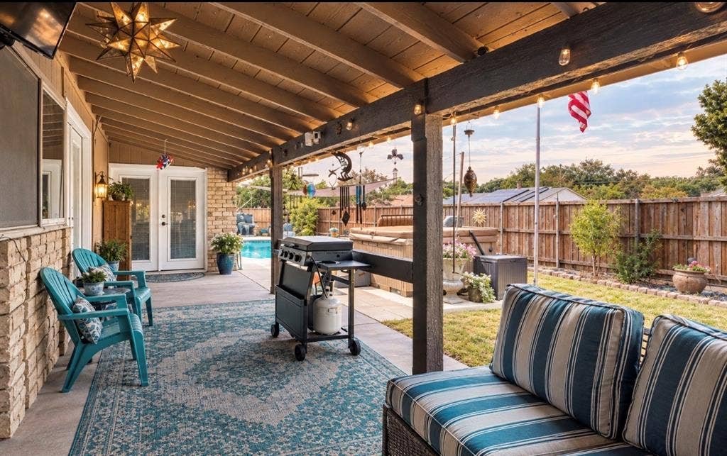 1216 Lombardy Drive, Plano, TX 75023 Covered patio with a wood-finish ceiling, brick facade, and string lights