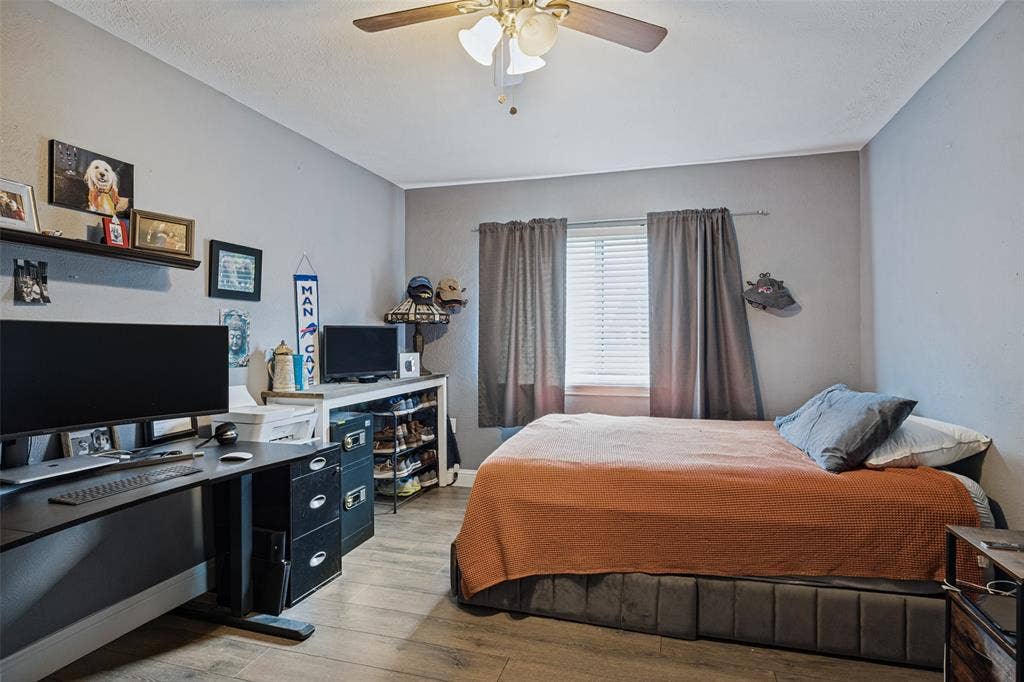 1216 Lombardy Drive, Plano, TX 75023 Room featuring a ceiling fan with integrated lighting, wood-finish flooring, and a window with blinds