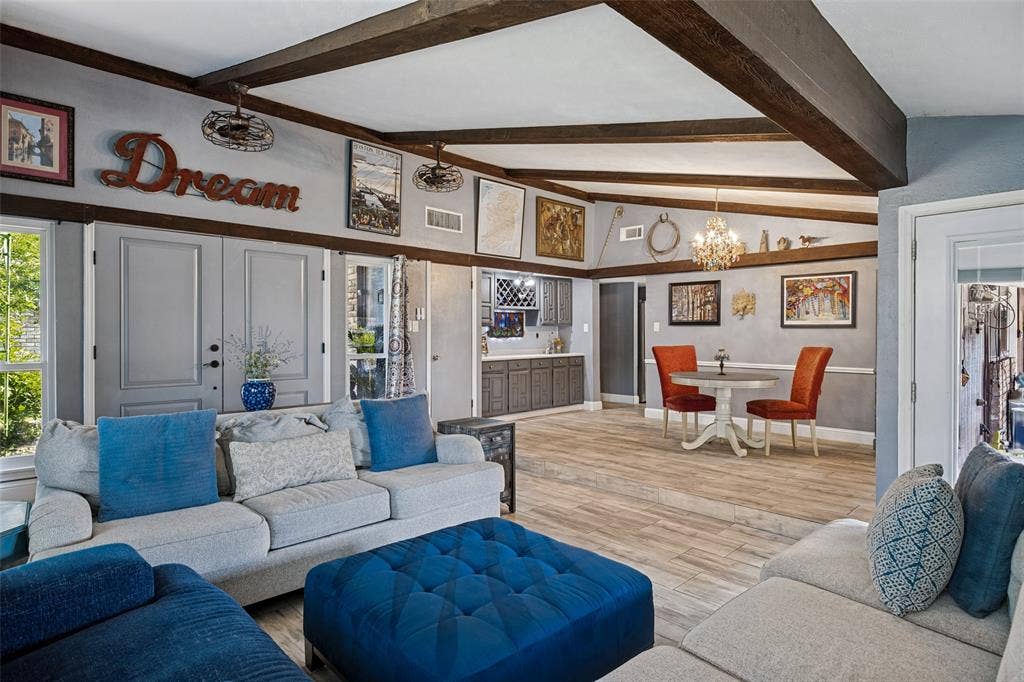 1216 Lombardy Drive, Plano, TX 75023 Exposed wood beams, wood-finish flooring, built-in cabinetry, and a crystal chandelier