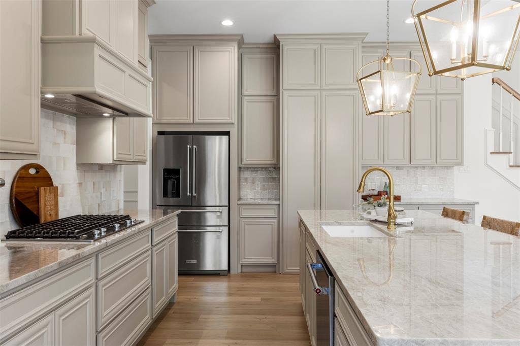 Gas range and huge walk in pantry through the double cabinet doors