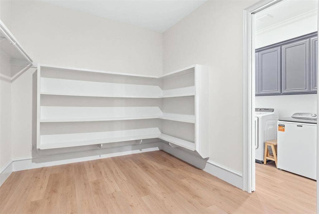 Primary Closet - virtually removed clothing, pocket door to laundry