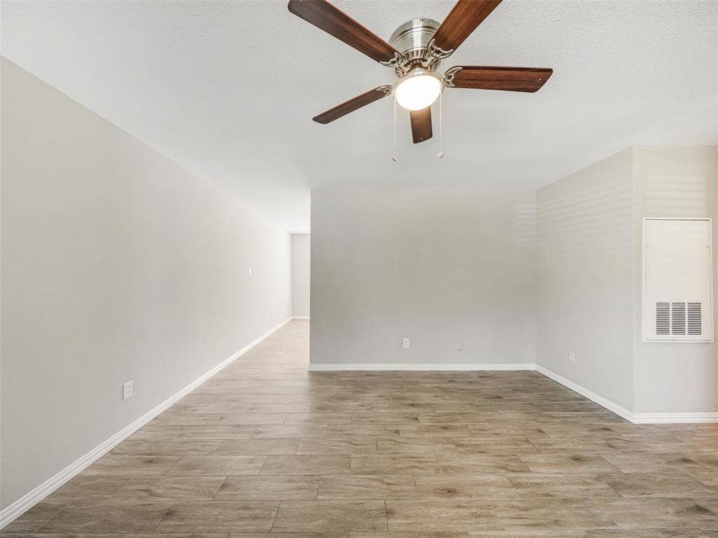 Recessed lighting, wood-finish flooring, ceiling fan with integrated lighting, neutral wall tones, and white trim