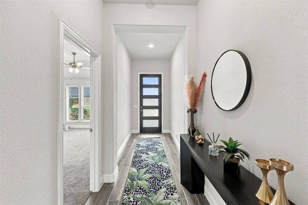 Entryway featuring wood-look flooring, a modern black entry door with frosted glass panels, and recessed lighting
