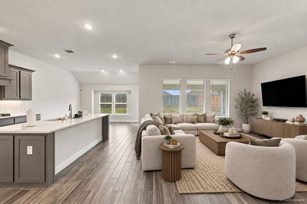 Integrated living space featuring wood-finish flooring, recessed lighting, and a ceiling fan