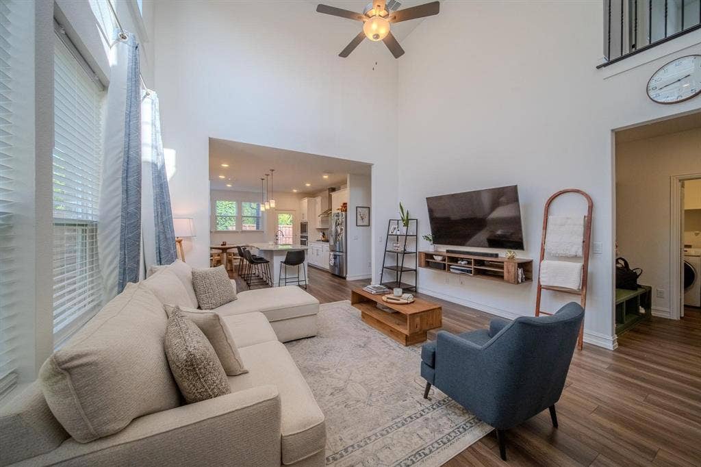 4629 Golden Gate Way, Garland, TX 75043 Vaulted ceilings, wood-finish flooring, and a ceiling fan with integrated lighting