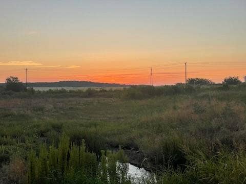 Sunrise backyard view featuring rural landscape