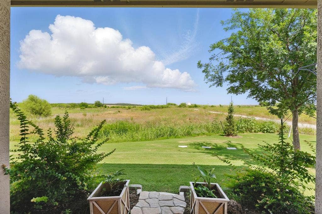 View of grassy yard with no neighbors behind.