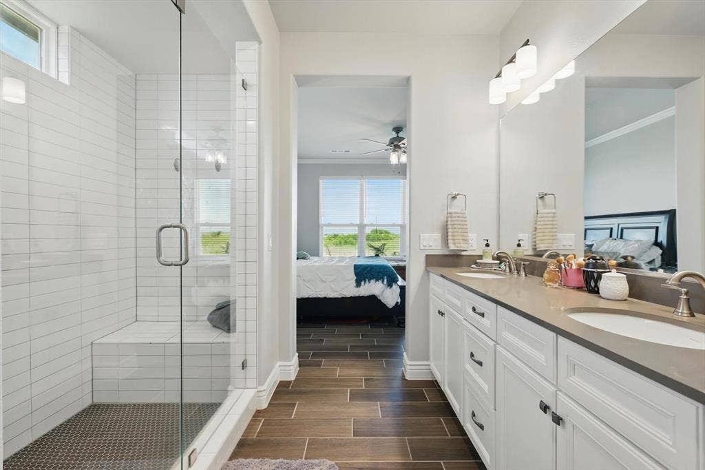 Frameless glass shower with stacked subway tile and bench .