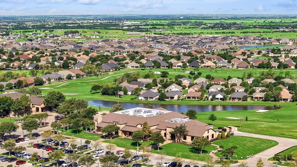 Aerial view of Clubhouse and pond on golf course.