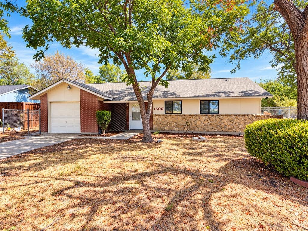 1500 Sherrye Drive, Plano, TX 75074 Brick and stucco exterior with a stone accent wall