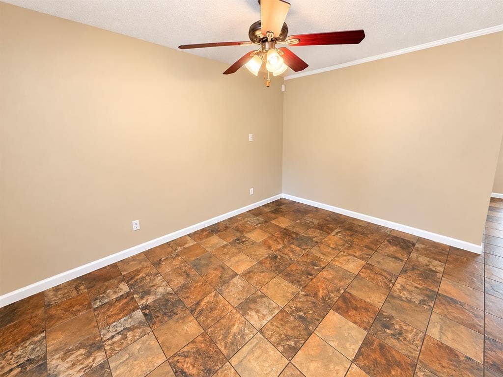 1500 Sherrye Drive, Plano, TX 75074 Textured tile flooring, ceiling fan with integrated lighting, neutral wall tones, white trim