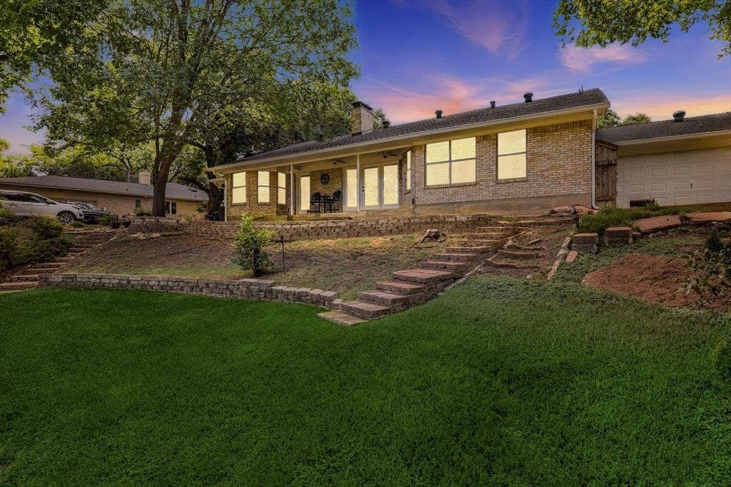 2811 Reedcroft Drive, Farmers Branch, TX 75234 Brick exterior home with a covered patio and multiple windows