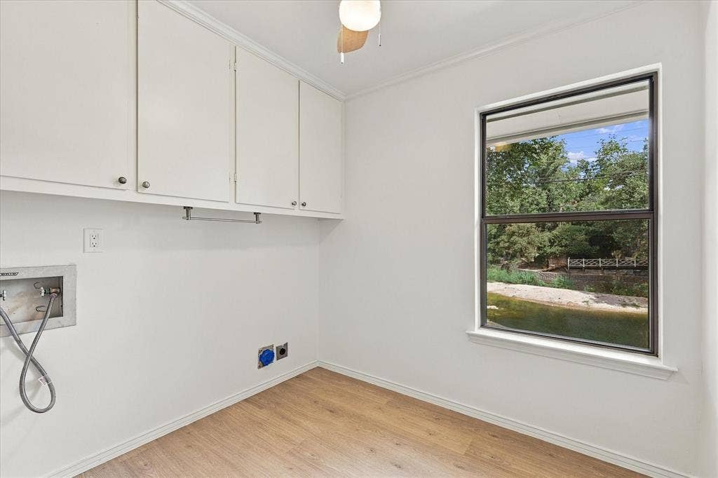 2811 Reedcroft Drive, Farmers Branch, TX 75234 Wood-finish flooring, white cabinetry, and a window with a natural backdrop