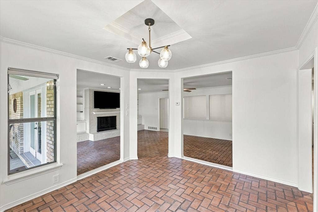 2811 Reedcroft Drive, Farmers Branch, TX 75234 Brick-pattern flooring with a modern multi-bulb chandelier