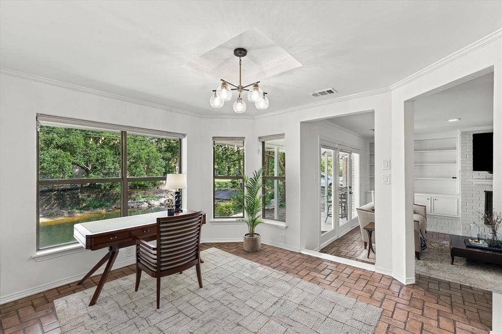 2811 Reedcroft Drive, Farmers Branch, TX 75234 Large windows, recessed ceiling detail, contemporary chandelier, brick-finish flooring, white built-in shelving