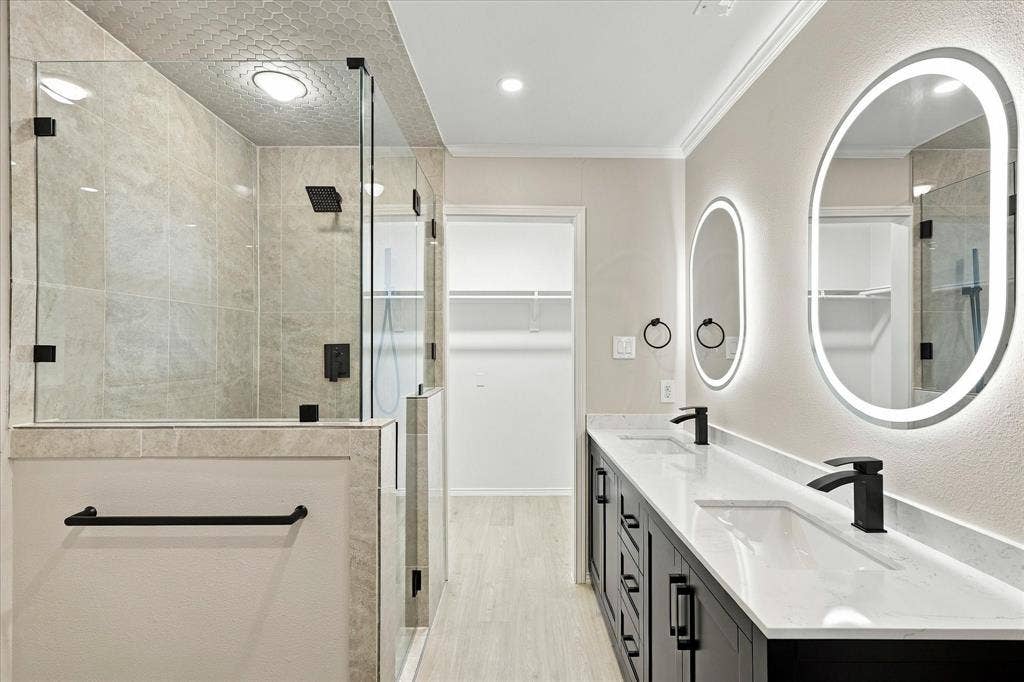 2811 Reedcroft Drive, Farmers Branch, TX 75234 Walk-in shower with full-height glass enclosure, dual vanity with quartz countertops, and illuminated oval mirrors