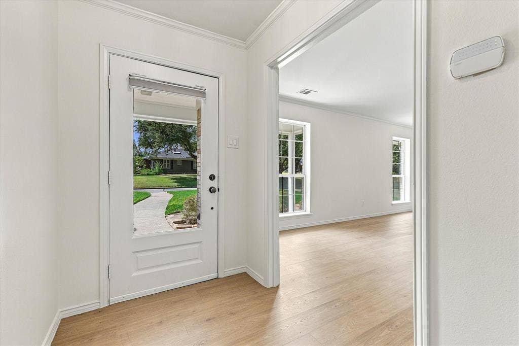2811 Reedcroft Drive, Farmers Branch, TX 75234 Transitional entryway with wood-finish flooring, white walls, and a full-light entry door