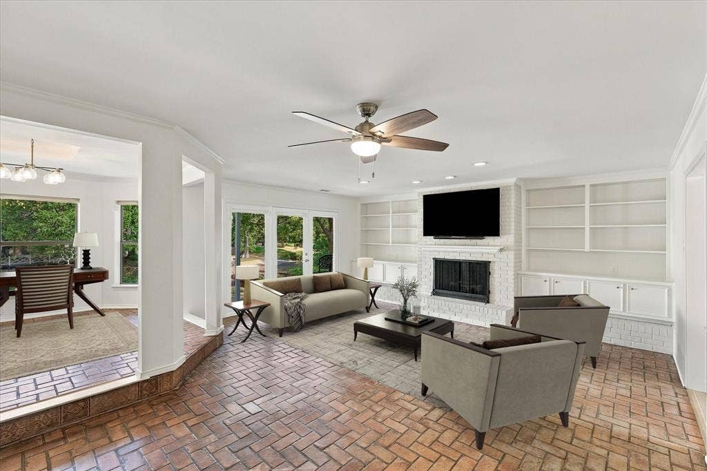 2811 Reedcroft Drive, Farmers Branch, TX 75234 Herringbone brick flooring, white brick fireplace, built-in shelving, recessed lighting, and multiple paneled glass doors