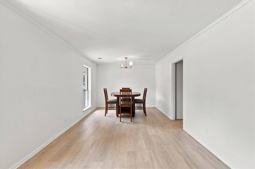 2811 Reedcroft Drive, Farmers Branch, TX 75234 Light wood-finish flooring, white walls, and crown molding