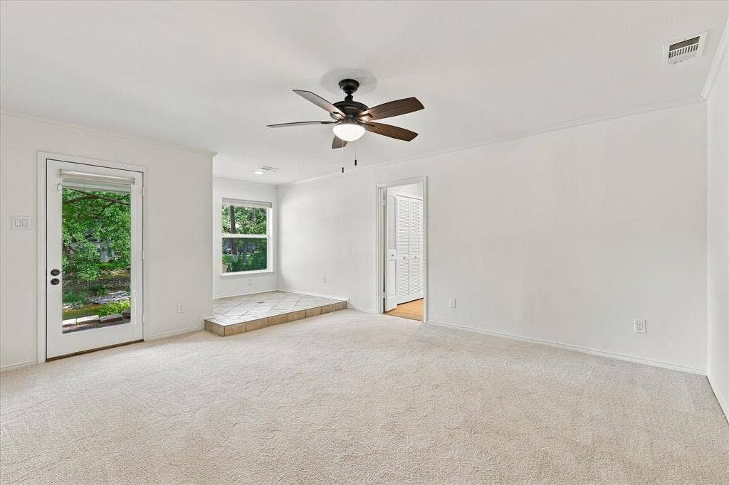 2811 Reedcroft Drive, Farmers Branch, TX 75234 Neutral carpeting, white painted walls, and a ceiling fan with integrated lighting