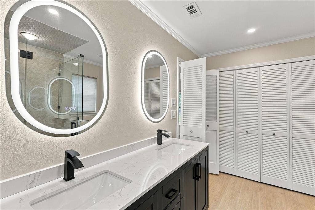 2811 Reedcroft Drive, Farmers Branch, TX 75234 Dual vanity with undermount sinks, stone-finish countertop, and matte black fixtures