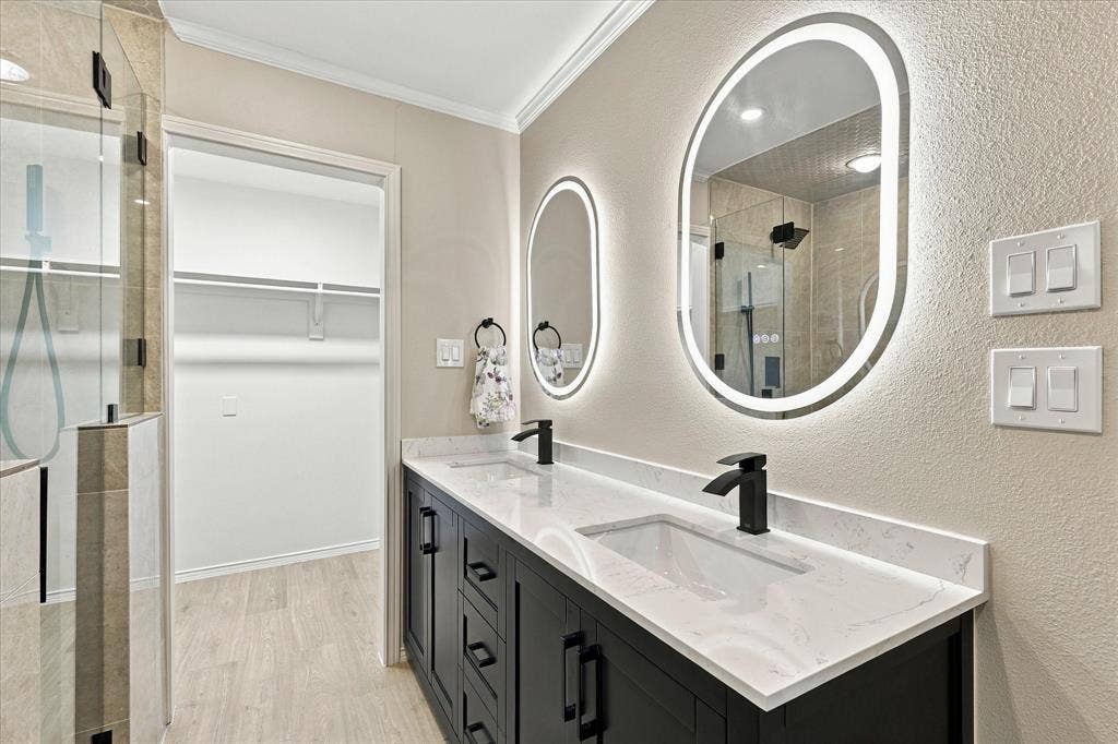 2811 Reedcroft Drive, Farmers Branch, TX 75234 Dual vanity with quartz countertops, matte black fixtures, and lighted mirrors