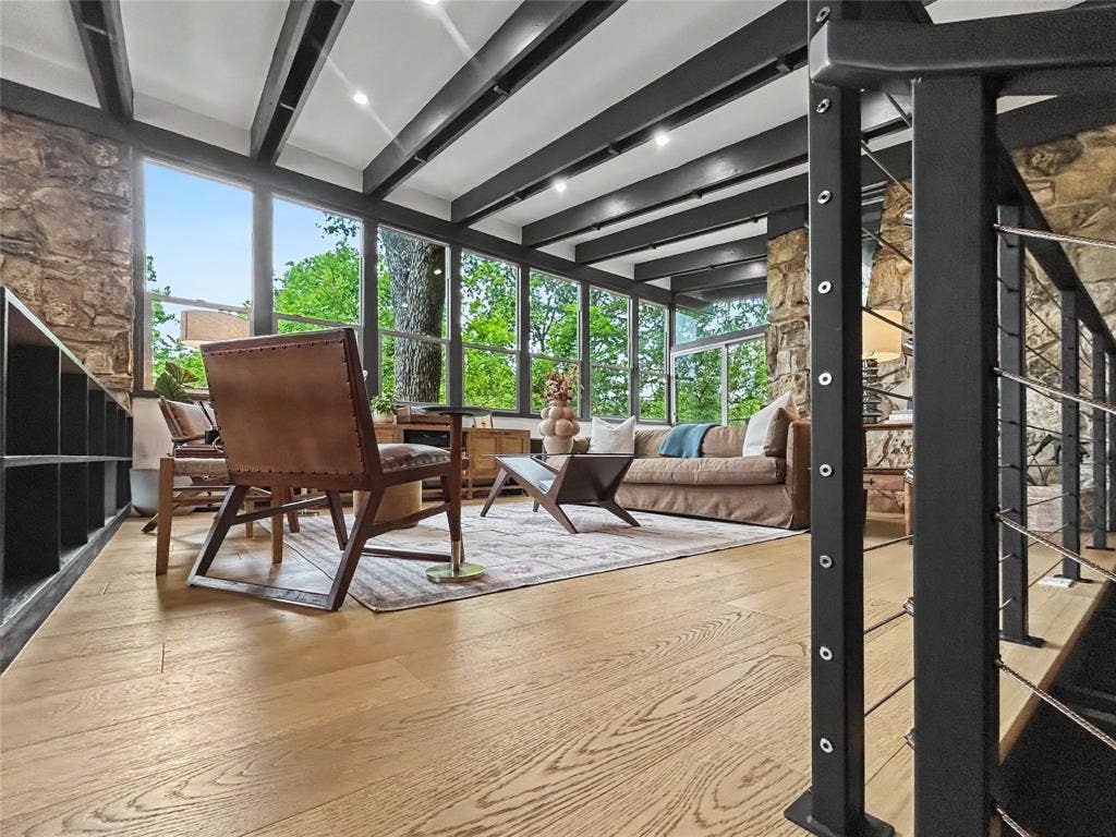 11737 Rogue Way, Dallas, TX 75218 MCM stone walls with open beams, a wall of windows, and treehouse vibes throughout