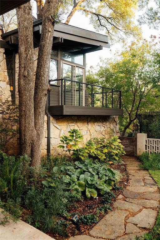 11737 Rogue Way, Dallas, TX 75218 Flagstone walkway and native landscape beneath treehouse kitchen balcony