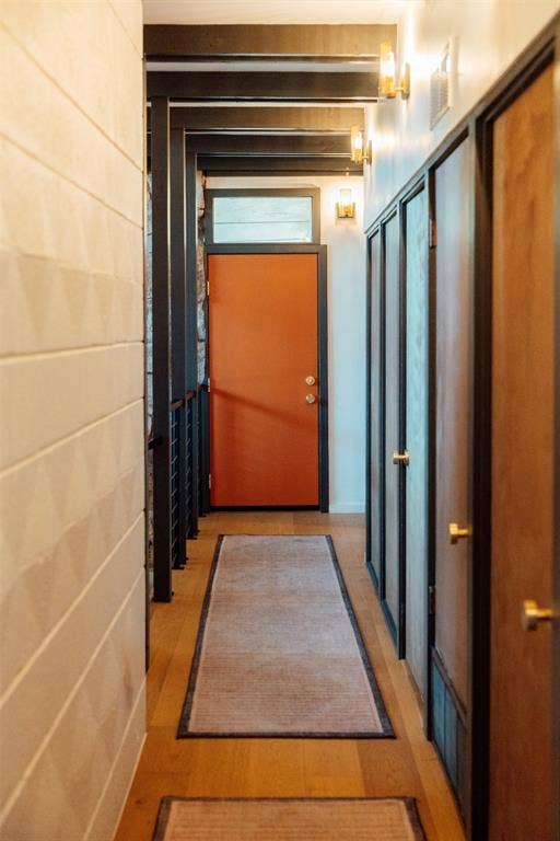 11737 Rogue Way, Dallas, TX 75218 Entry hall with brass sconces, geometric wall, and custom 34" orange front door