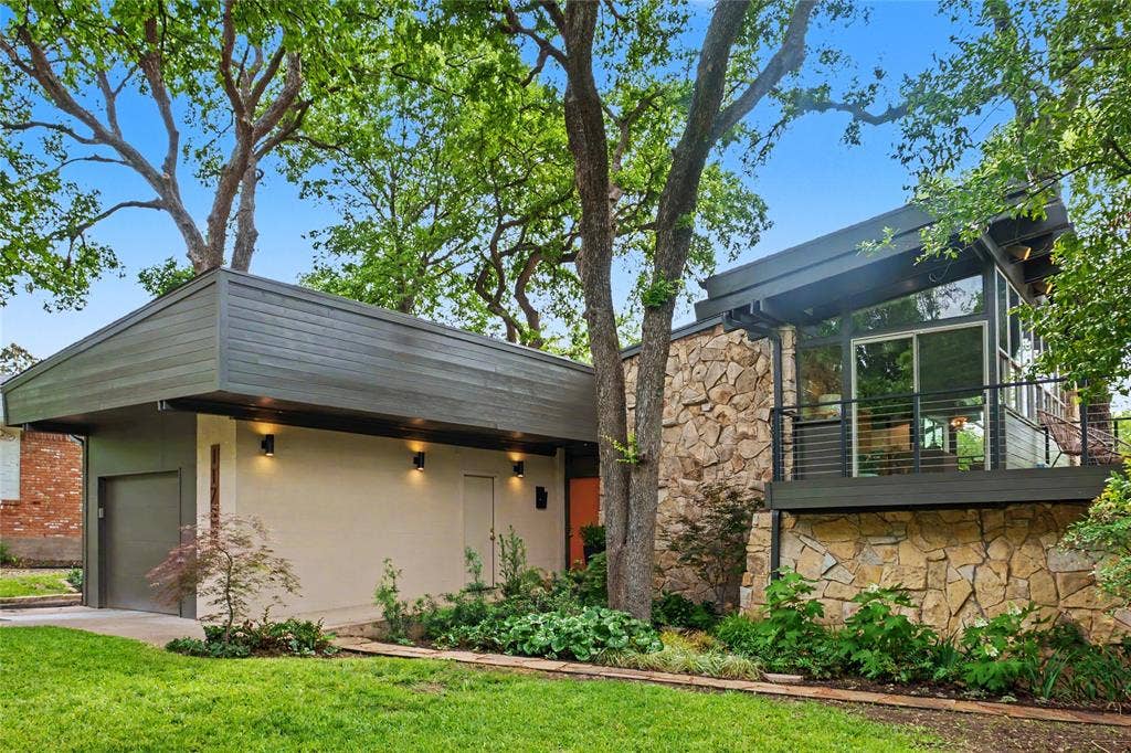 11737 Rogue Way, Dallas, TX 75218 Lit sconces and a glass-walled living area up in the canopy... one of many balconies