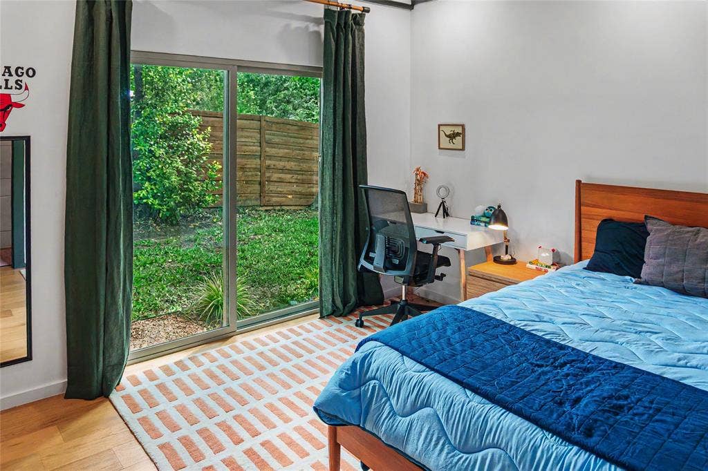 11737 Rogue Way, Dallas, TX 75218 Bright guest bedroom with garden views on the entry level