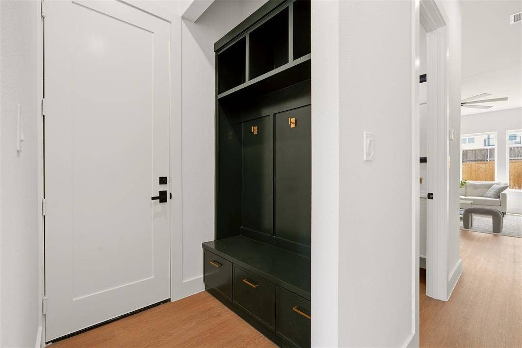 6911 Mohawk, Dallas, TX 75235 Built-in dark cabinetry with integrated bench seating, brass-finish hardware, and storage cubbies