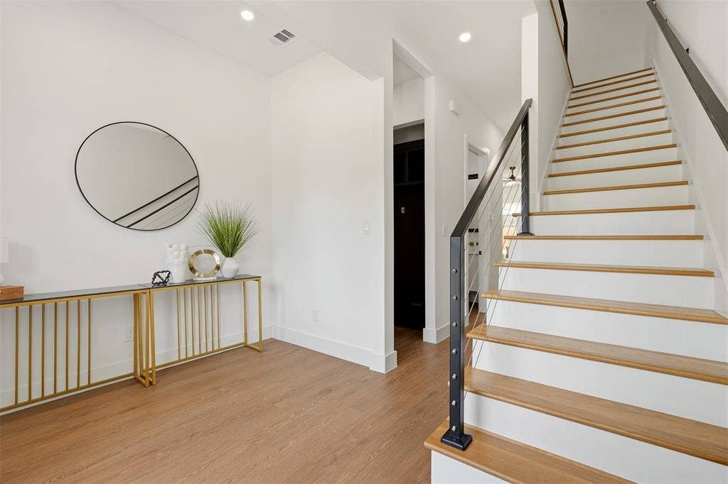 6911 Mohawk, Dallas, TX 75235 Wood-finish flooring, recessed lighting, white walls, and a staircase with wood treads and a cable railing system