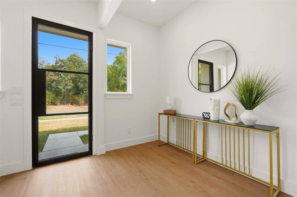 6911 Mohawk, Dallas, TX 75235 Wood-finish flooring, white walls, and a black-framed glass entry door