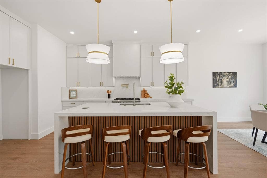 6911 Mohawk, Dallas, TX 75235 Kitchen island with a white countertop and wood-finish paneling