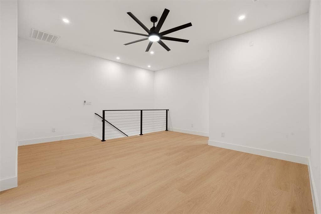 6911 Mohawk, Dallas, TX 75235 Recessed lighting, wood-finish flooring, contemporary ceiling fan, and modern cable railing